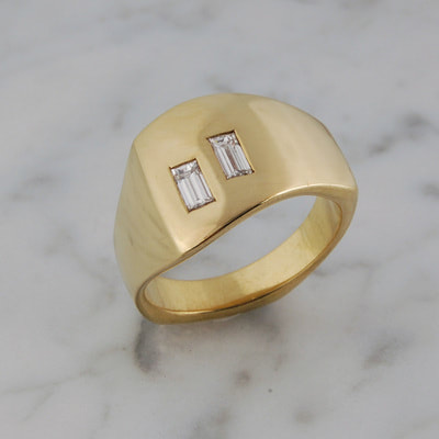18 Karat Yellow Gold slant band with squared top and baguette diamonds.
