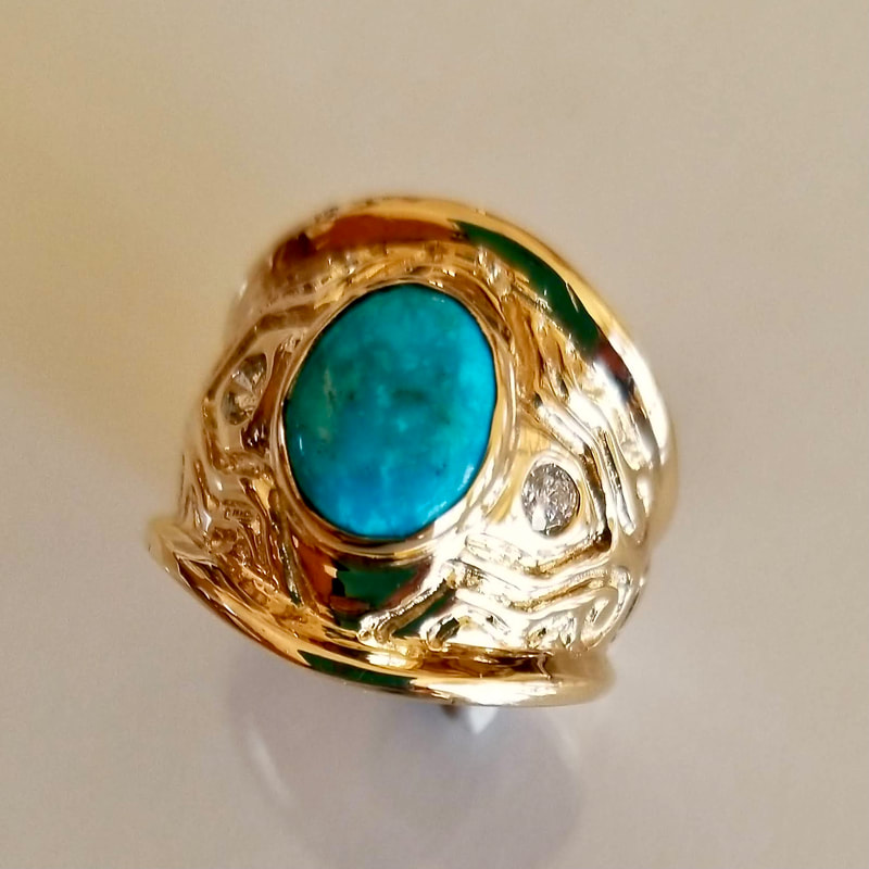 Wide patterned gold ring with Turquoise and inset diamonds.