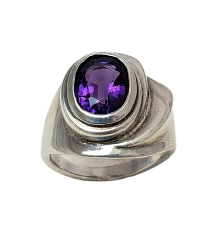 Sterling Silver ring with one oval shaped Amethyst in the center.