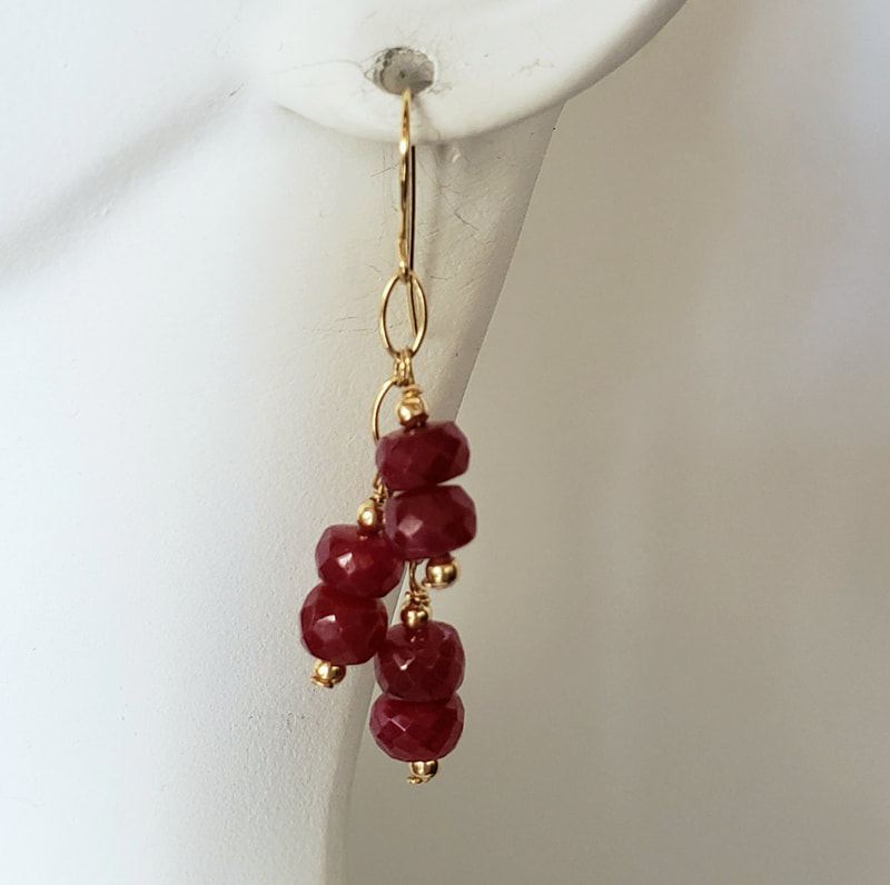 14 Karat Yellow Gold French wire dangle earrings with faceted Ruby beads.