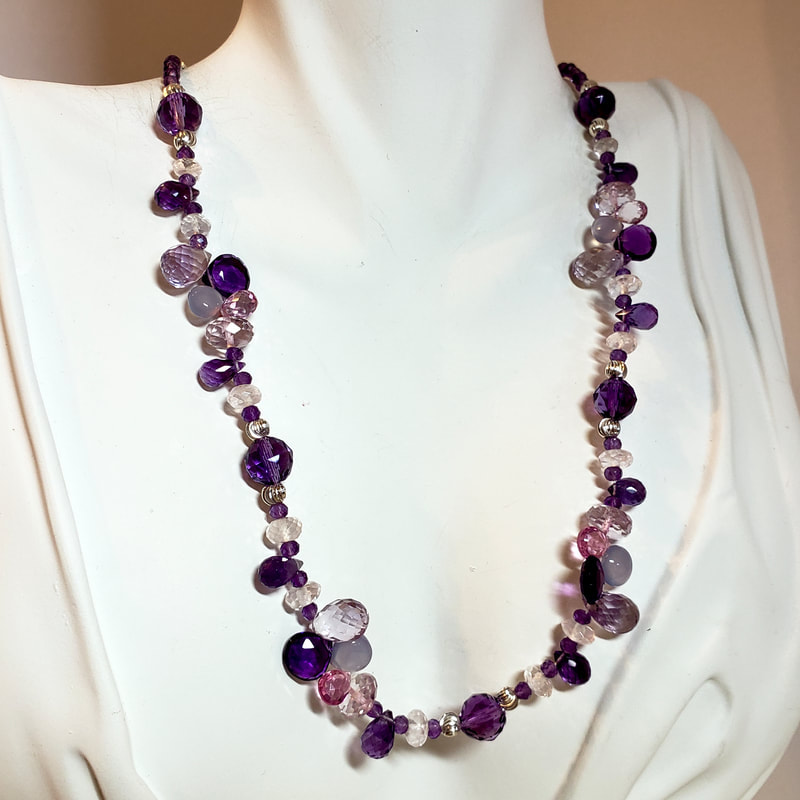 Sterling Silver Bead necklace with multiple shaped gemstones in purple hues.