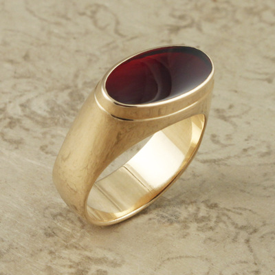 14 Karat Yellow Gold flat topped ring with an Oval Garnet inlayed  on the top.