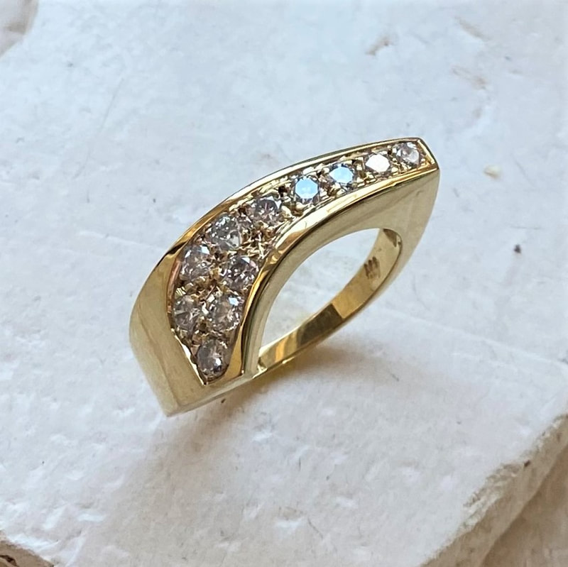 18 Karat Yellow Gold ring with diamonds.