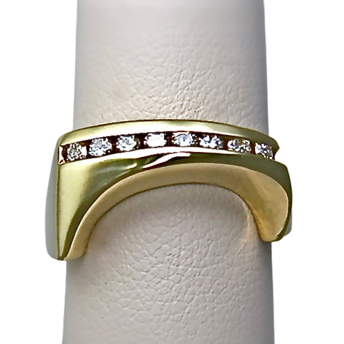 18 Karat Yellow Gold ring with channel set diamonds across the top and angled down sections on gold on each side.