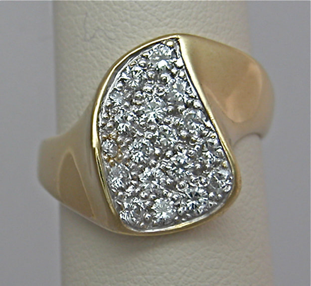 18 Karat Yellow Gold ring with pave set diamonds.