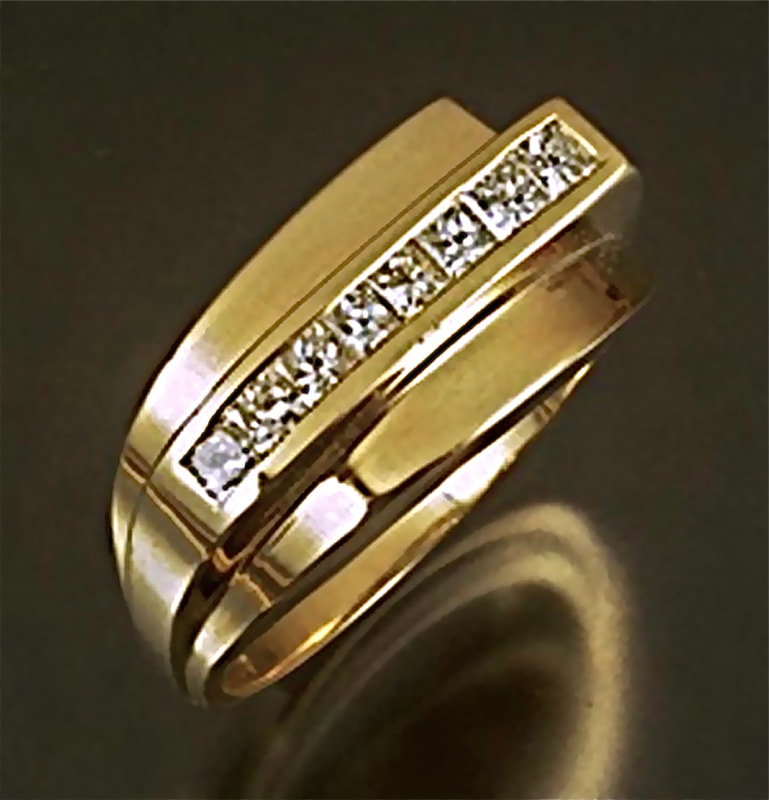18 Karat Yellow Gold ring with channel set princess cut diamonds.
