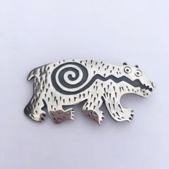 Sterling Silver bear shape pin with a darkened spiral design.