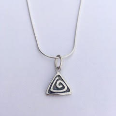 Sterling Silver triangular shaped charm with a spiral design and an oxidized background.