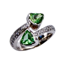 14 Karat White Gold bypass ring with two trillion shaped Green Tourmalines and diamonds down each side.
