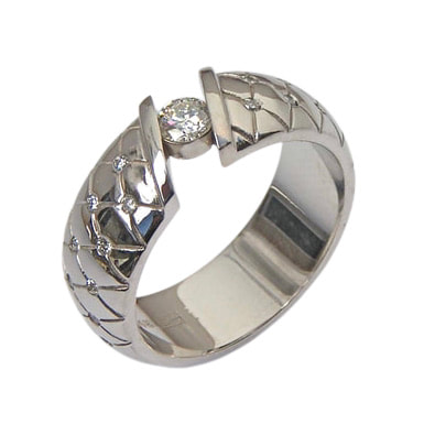 14 Karat White Gold ring with one tension - set round Diamond and flush set spaced Diamonds down each side of the band.