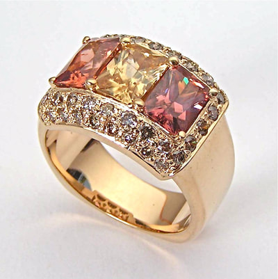 14 Karat Yellow Gold Ring with three rectangular Zircons and Champagne Diamond surrounding them.