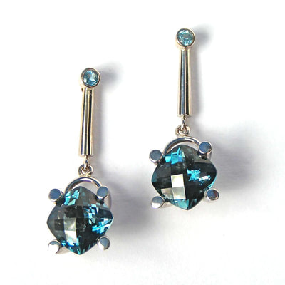 14 Karat White Gold post earrings with checkerboard faceted square cushion shaped Blue Topaz.