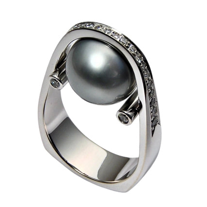 14 Karat White Gold ring with one Tahitian Black Pearl and diamonds on the band that goes over the top of the pearl.