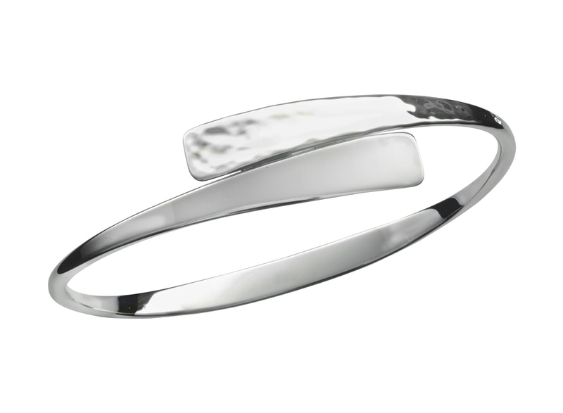 Sterling Silver bangle bracelet with a hinge to open the top with a heart revealed when open.