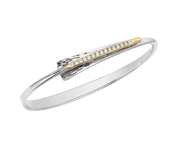 Sterling Silver bangle bracelet with a tapering, hammered top and a 14 Karat Yellow Gold line in the center with channel set diamonds.
