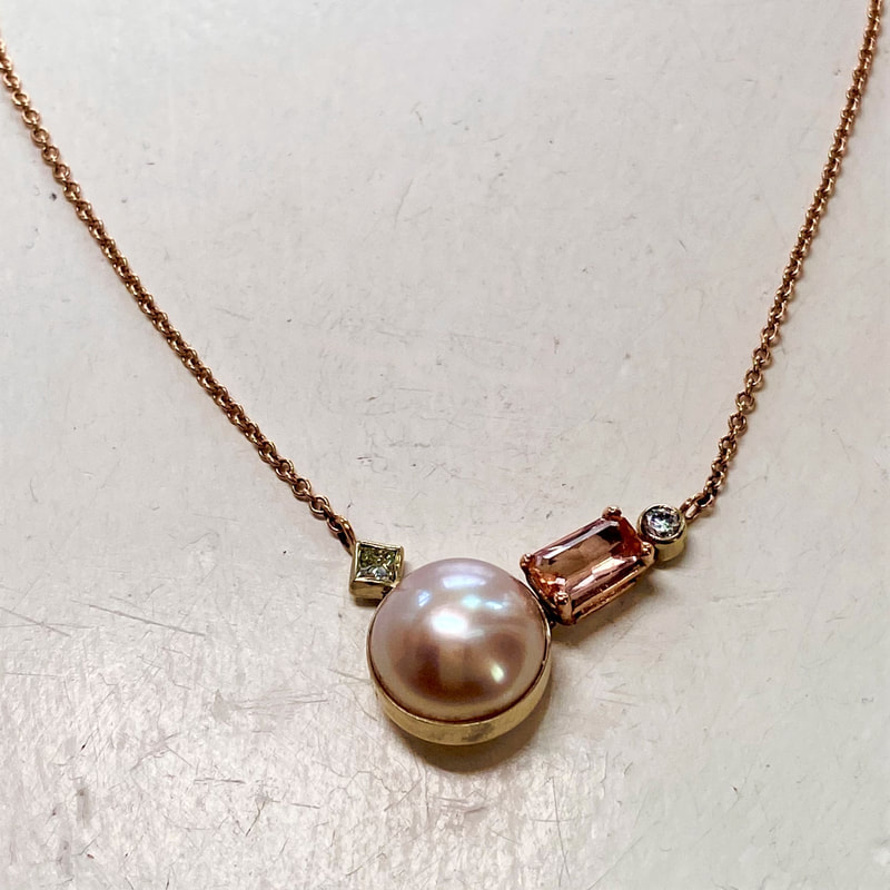 14 Karat Rose and White Gold Pendant with a round cultured button pearl, a rectangular shaped Imperial Topaz and two diamonds.