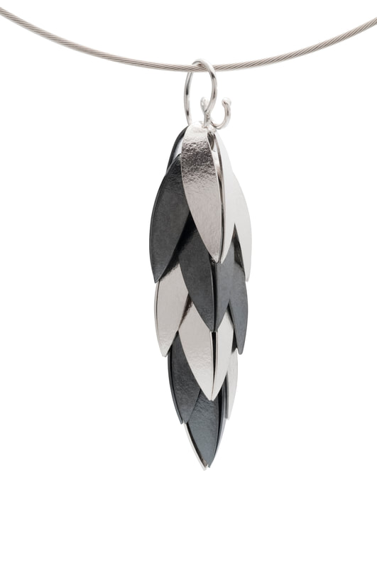 Sterling Silver Two-tone pendant with Layers of silver leaf shapes.