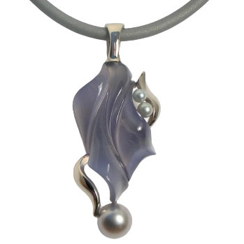 14K White Gold carved Chalcedony pendant with pearls on a gray neoprene neck wire.