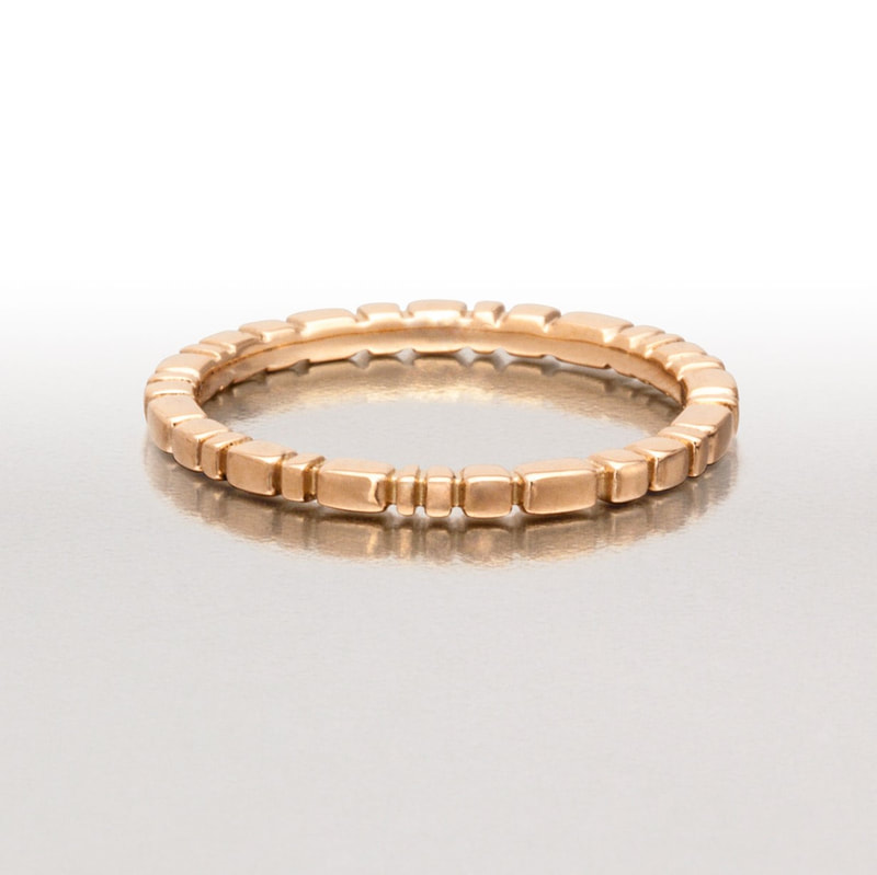 18 Karat Rose Gold thin band ring with notches all the way around.