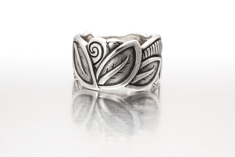 Platinum Sterling Silver wide band ring with carved leaves.
