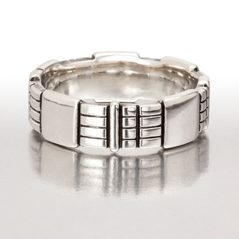 Platinum Sterling Silver 7mm band with notched designs all the way around.