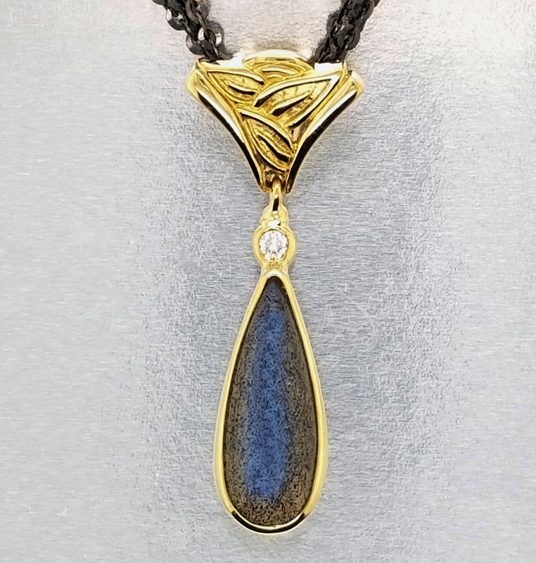 18KY carved leaves  Pendant with a pear shaped Moonstone and Diamond on a 3 Strand Blackened chain.