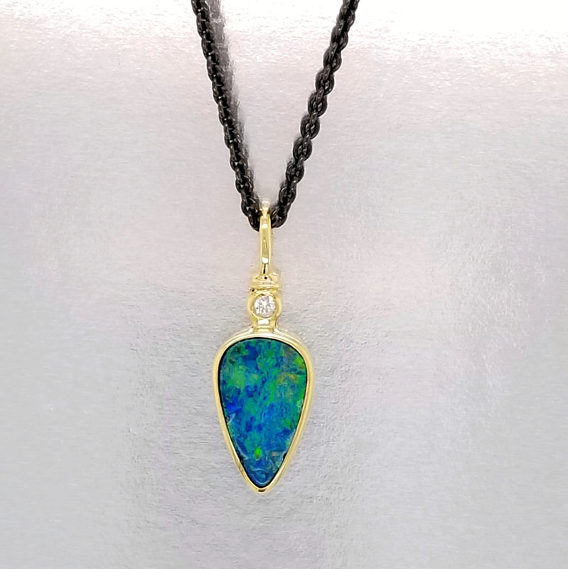 18KY Boulder Opal & Diamond Pendant on a Sterling Silver Black Rhodium Plated Chain.