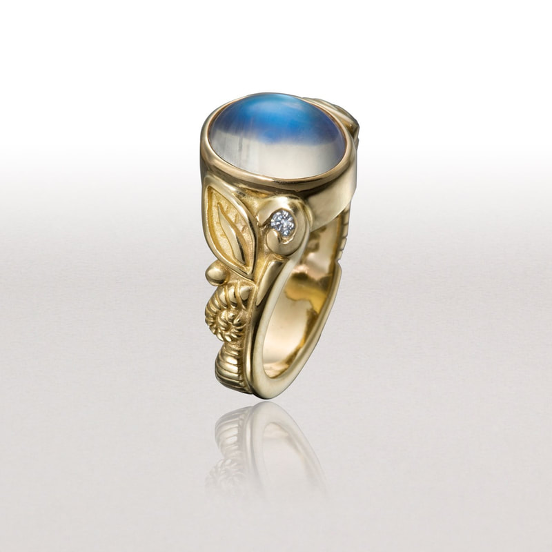 18 Karat Yellow Gold Diamond & Moonstone Ring with carved leaves on the band.