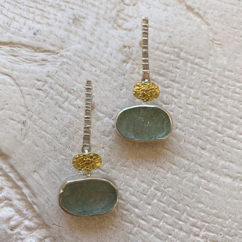 Silver and 22 Karat Yellow Gold Bi-Metal with oval natural face aquamarine post earrings.