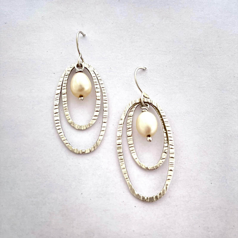 Silver French wire earrings with double oval dangles & one pearl dangle in the center.