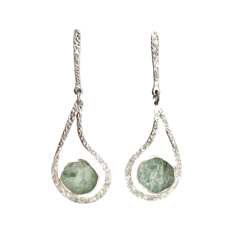 Open tear drop Sterling Silver earrings with Natural Face Aquamarine in the center.