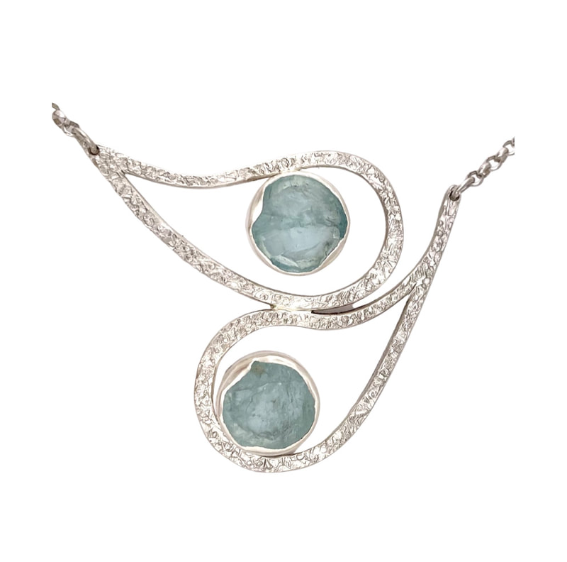 Double open tear drop Sterling Silver pendant with Natural Face Aquamarine in the center of each.