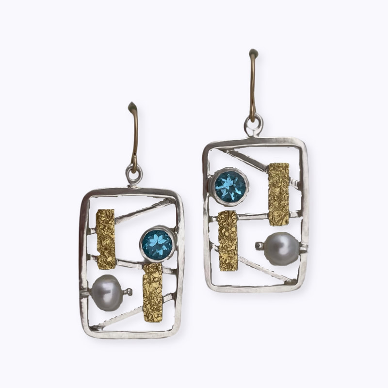 22 Karat Yellow Gold and Sterling Silver Bi-metal earrings with Blue Topaz and pear with a silver open frame.