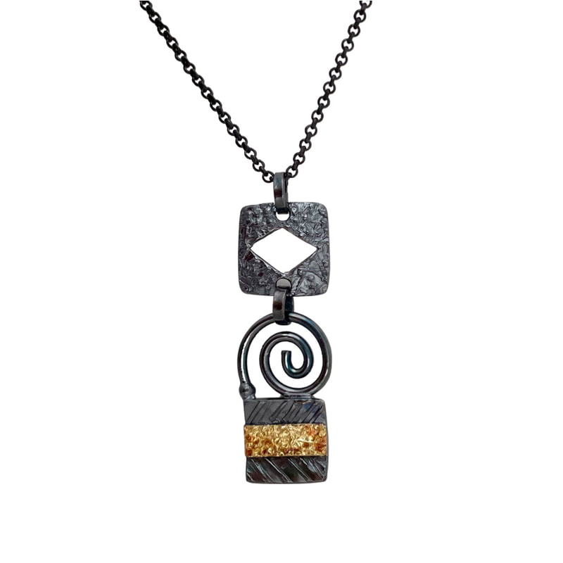 22 Karat Yellow Gold and blackened Sterling Silver pendant with multiple shapes on a blackened chain.