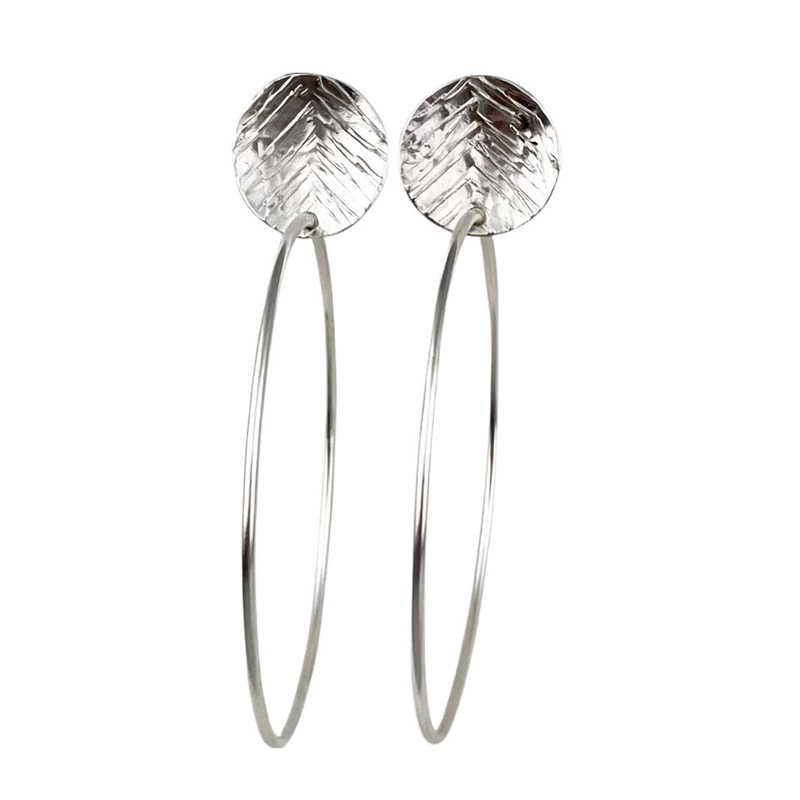 Sterling Silver post back earrings with a textured disc station on the top with a hoop on the bottom.