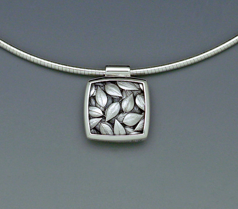 Sterling Silver Square shaped pendant that is Reversible and on a Silver wire chain.