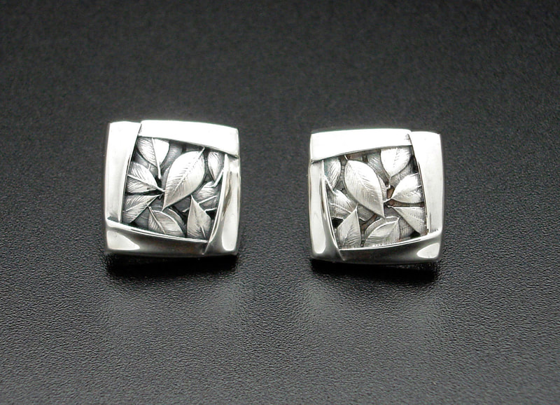 Sterling Silver square Omega back earrings with carved leaves and 14 Karat Yellow Gold posts.