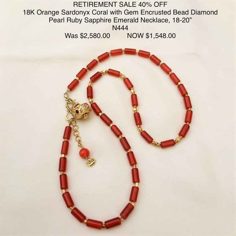 18 Karat Yellow gold necklace with elongated Red Coral beads alternating with gold beads and a dangling large bead with Ruby, Pearl, Sapphire, Diamond and Emerald.