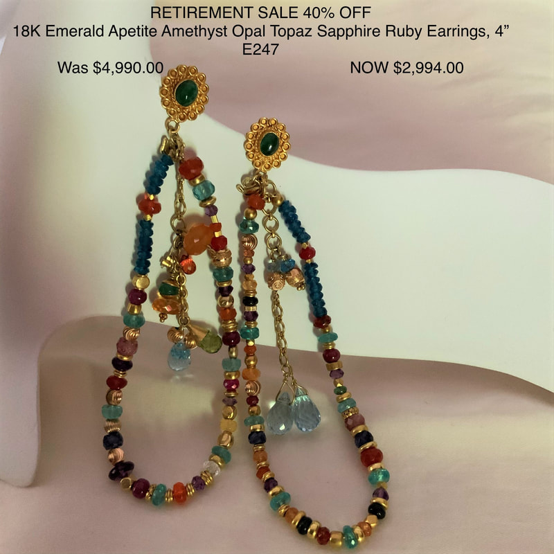 18 Karat Yellow Gold post earrings with a gold station set with an Emerald in the center and loops of different gemstone beads and dangles hanging from it.