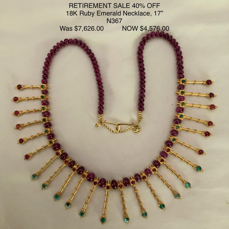 18 Karat Yellow Gold necklace with smooth Ruby beads and gold straight stations radiating from the necklace with an Emerald and Ruby on each.
