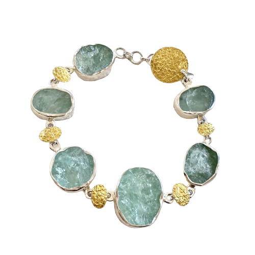 Silver and 22 Karat Yellow Gold Bi-Metal link bracelet with oval natural face aquamarines.