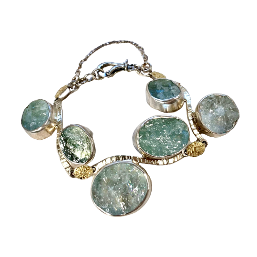 Silver and 22 Karat Yellow Gold Bi-Metal link bracelet with off-set natural face aquamarines.