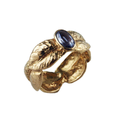 Yellow gold sculpted leaf band with one sapphire in the center.