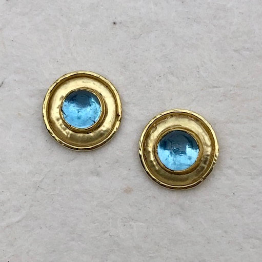 High Karat Yellow Gold post earrings with round Blue Topaz with frames of gold around them.