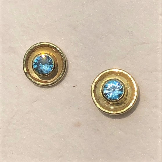 Round Blue Zircon studs with a 22KY bezel and an outer edge of 18KY gold.