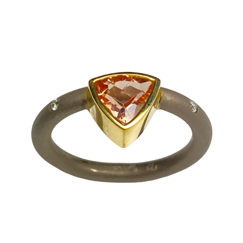 18 Karat Yellow & 18 Karat White Gold Ring with one off-set trillion shaped Precious Topaz & flush-set Diamonds on the band.