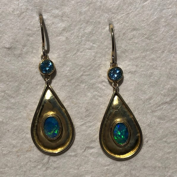 22 Karat and 18 Karat Yellow Gold dangle earrings with a Blue Topaz on the top and a teardrop shape with Opal.