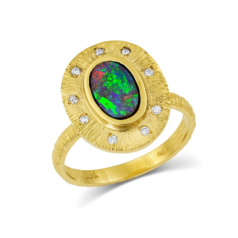 14 Karat Yellow Gold ring with an oval opal in the center with a Bezel and diamonds.