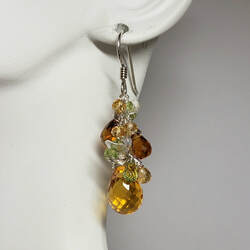 Sterling Silver French Wire dangle earrings with different sizes and shades of Citrine briolette shaped gems and peridot.