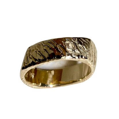 Yellow gold square slightly slanted band with carved texture.